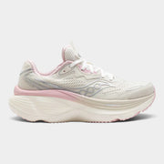 A Saucony running shoe in off-white and light pink, featuring a chunky white midsole with a pink accent layer and a silver Saucony logo on the side, set against a light gray background.