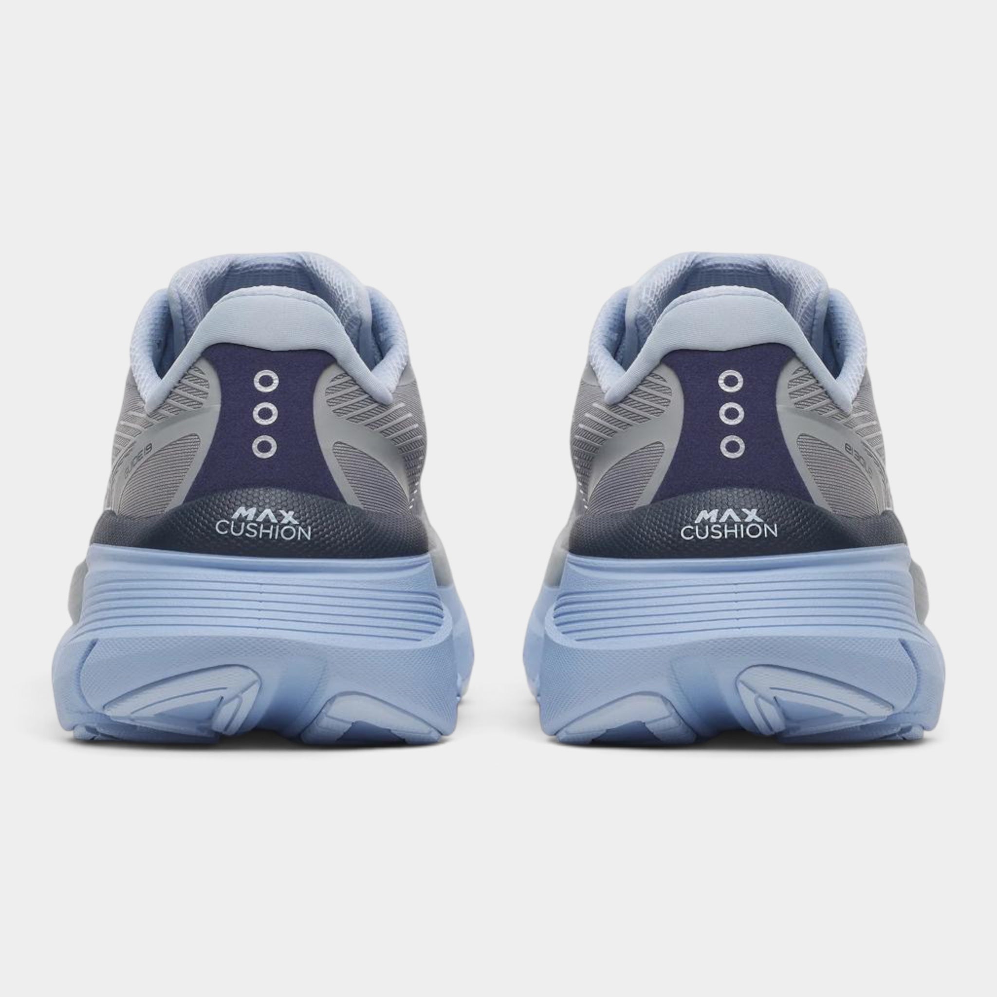 A pair of athletic sneakers shown from the rear, featuring a light blue and gray design with a dark navy heel counter and the text 'MAX CUSHION' printed on the heel.