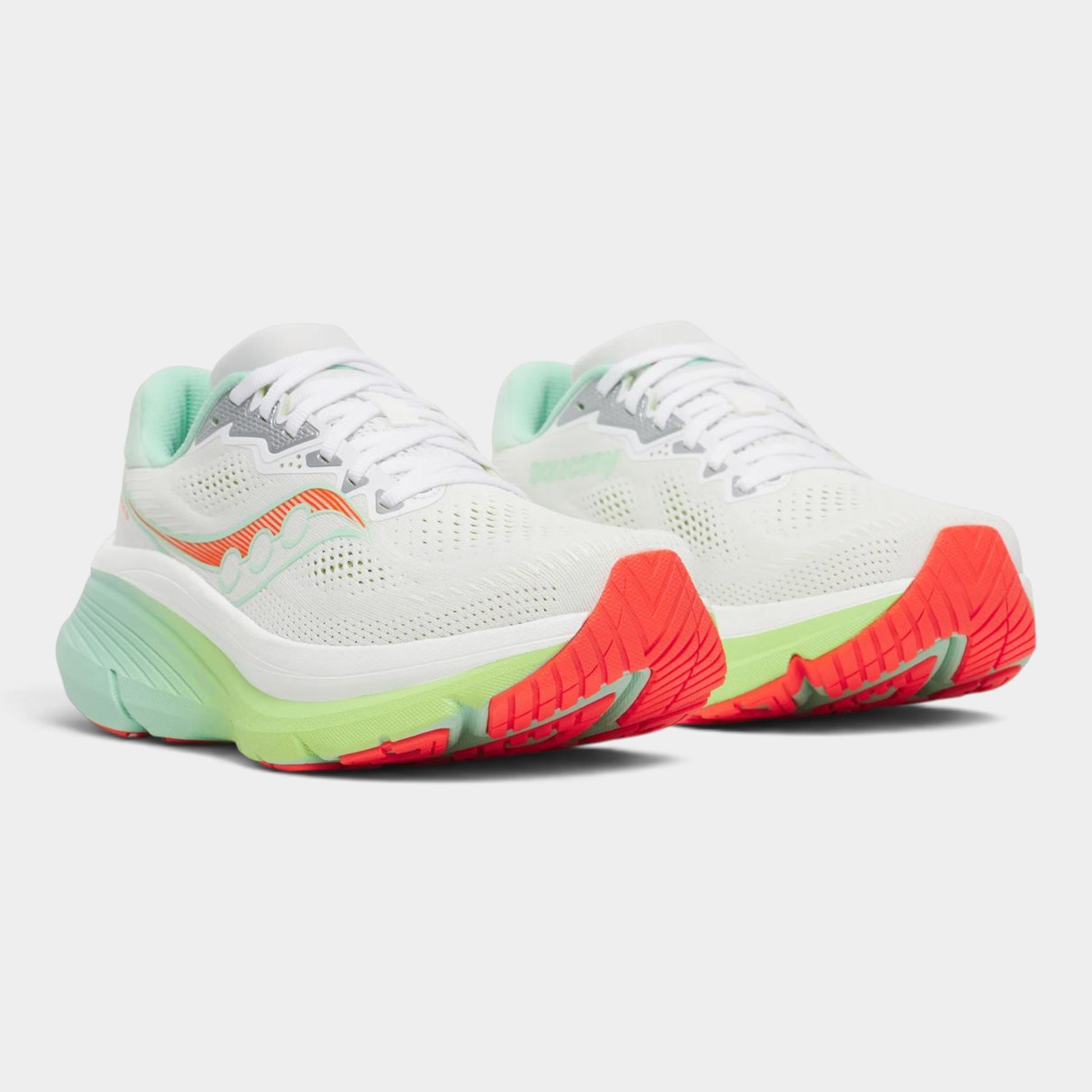 A pair of Saucony running shoes in white with mint green, neon orange, and bright coral accents, shown against a light gray background.