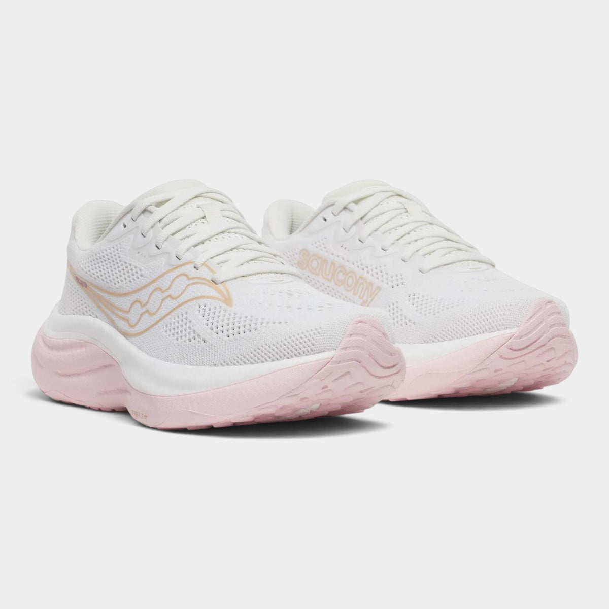A pair of Saucony athletic sneakers in white and light pink, featuring a textured mesh upper, white laces, and a wavy gold logo on the side.