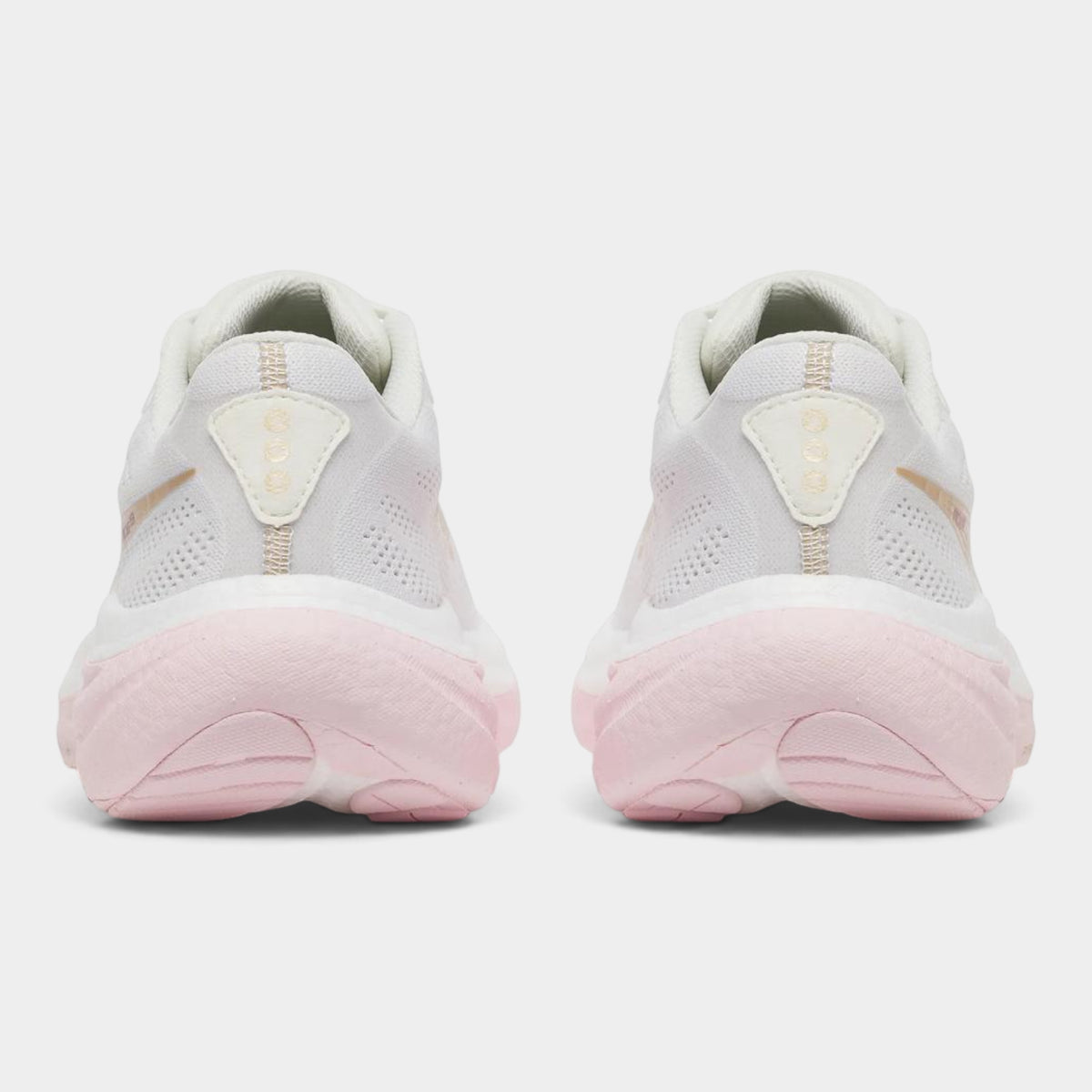A pair of white running shoes shown from the back, featuring light pink midsoles and heel accents with a small gold logo on a clean light gray background.