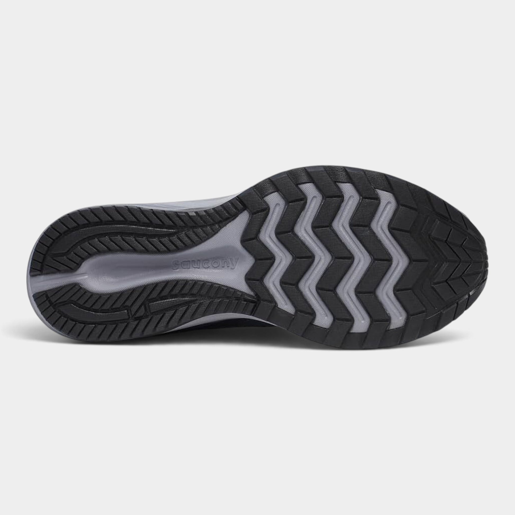 The outsole of a running shoe, showing a black tread pattern with gray chevron-like accents and a gray heel insert, photographed on a light gray background.