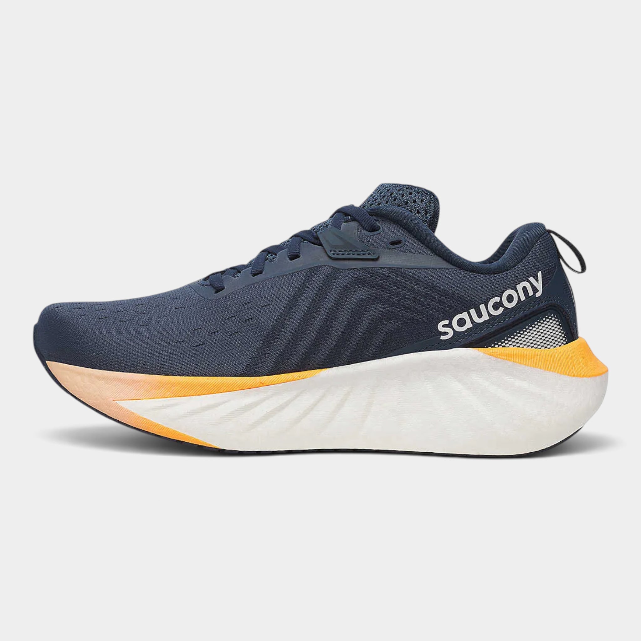 A Saucony running shoe in navy blue with a thick white midsole and bright yellow-orange accents, shown from the side on a light gray background.
