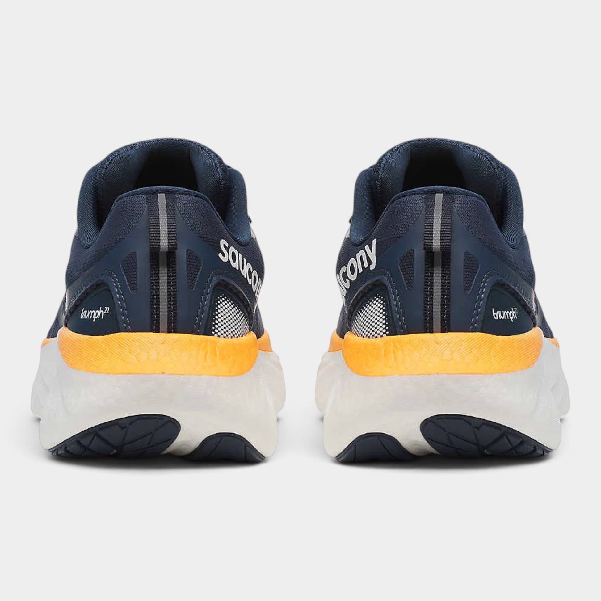 A pair of Saucony running shoes shown from the back, featuring a navy blue upper, a bright yellow midsole accent, and a white and navy outsole.