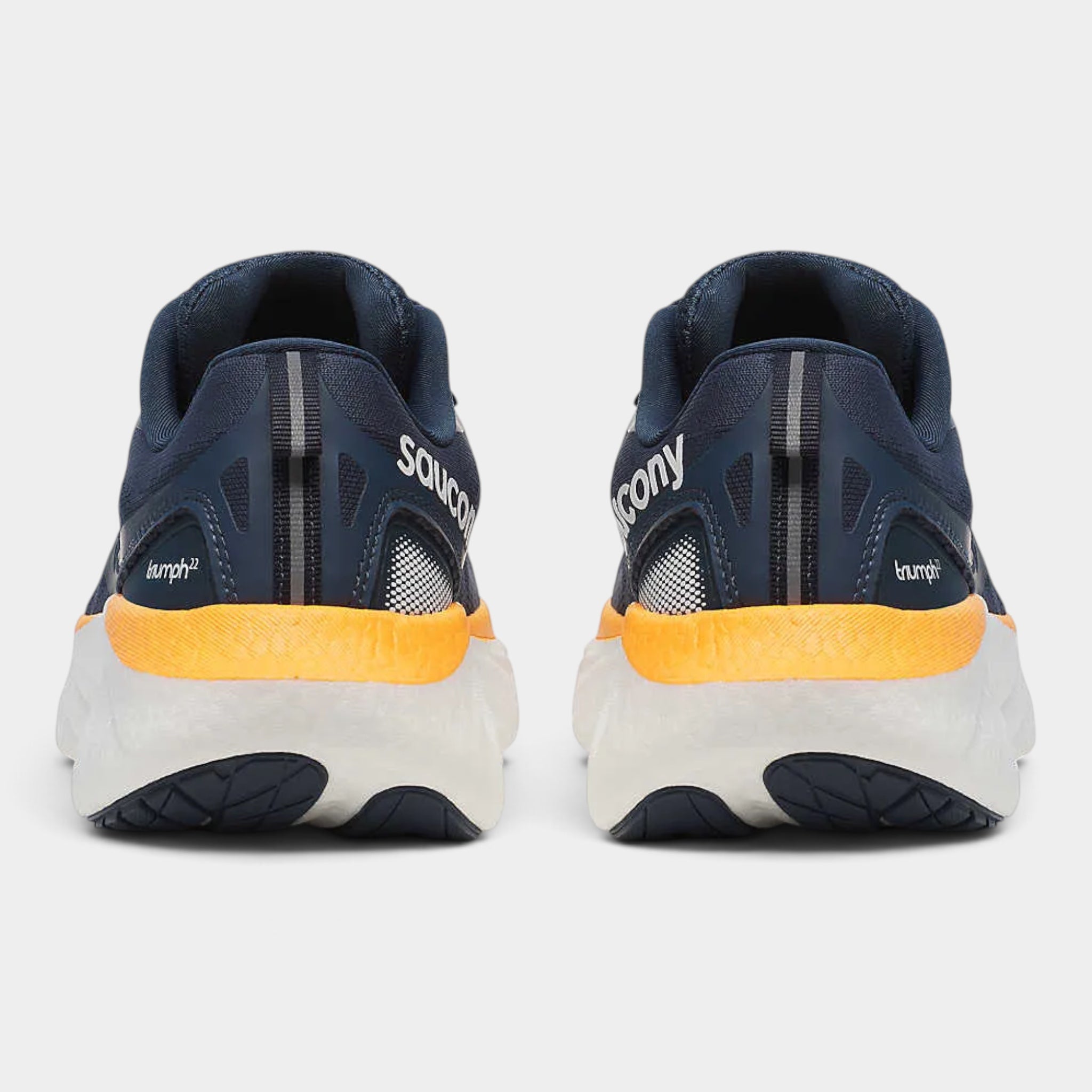 A pair of Saucony running shoes shown from the back, featuring a navy blue upper, a bright yellow midsole accent, and a white and navy outsole.
