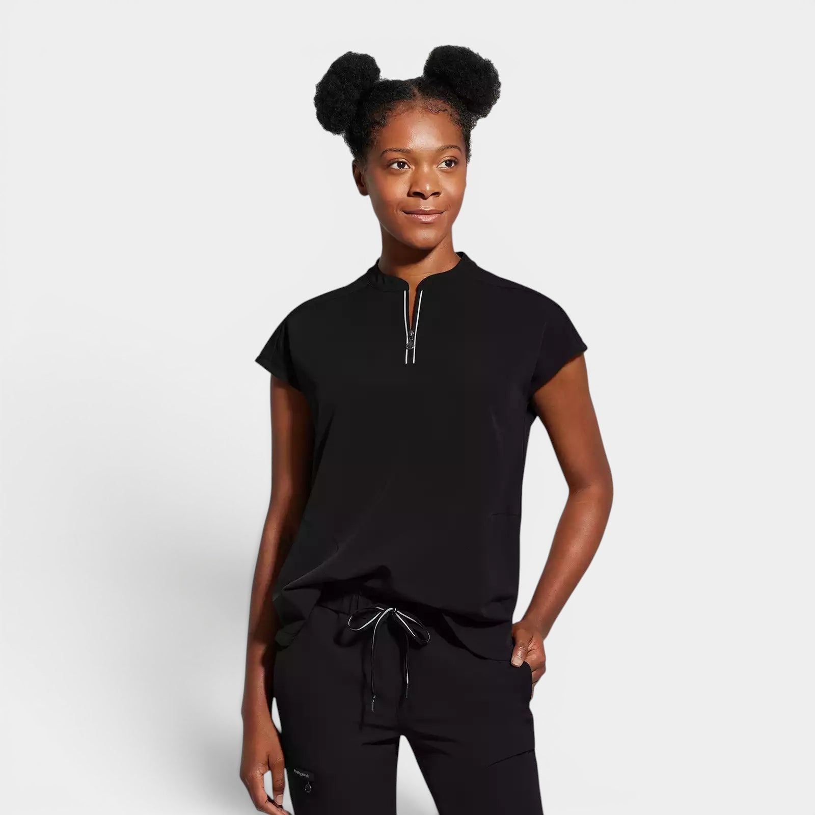 Read's Uniforms black scrub top with partial zip front, dolman sleeves, and rounded hem. Model is wearing matching pants.