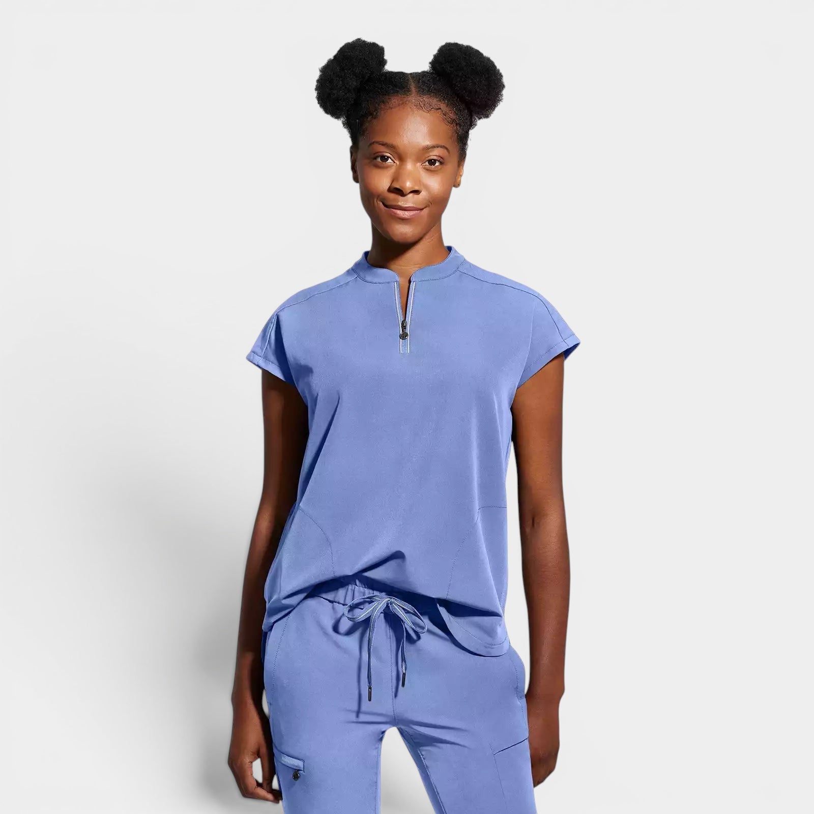 Read's Uniforms periwinkle blue knit scrub top with dolman sleeves, side vents, and partial zip front.
