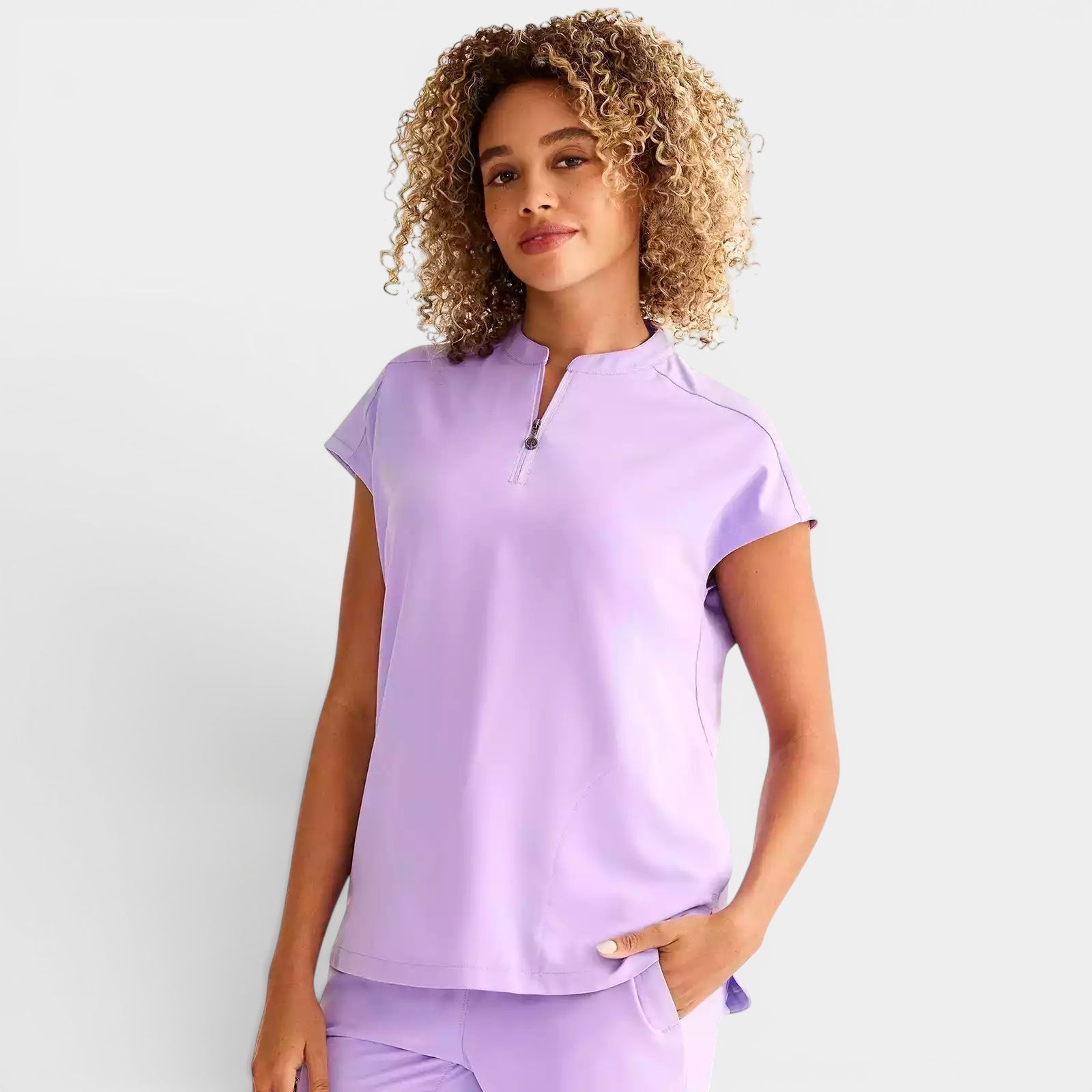 Read's Uniforms Sandy Top: relaxed fit, lavender scrub top with dolman sleeves, partial zip front, side vents, and rounded hem.