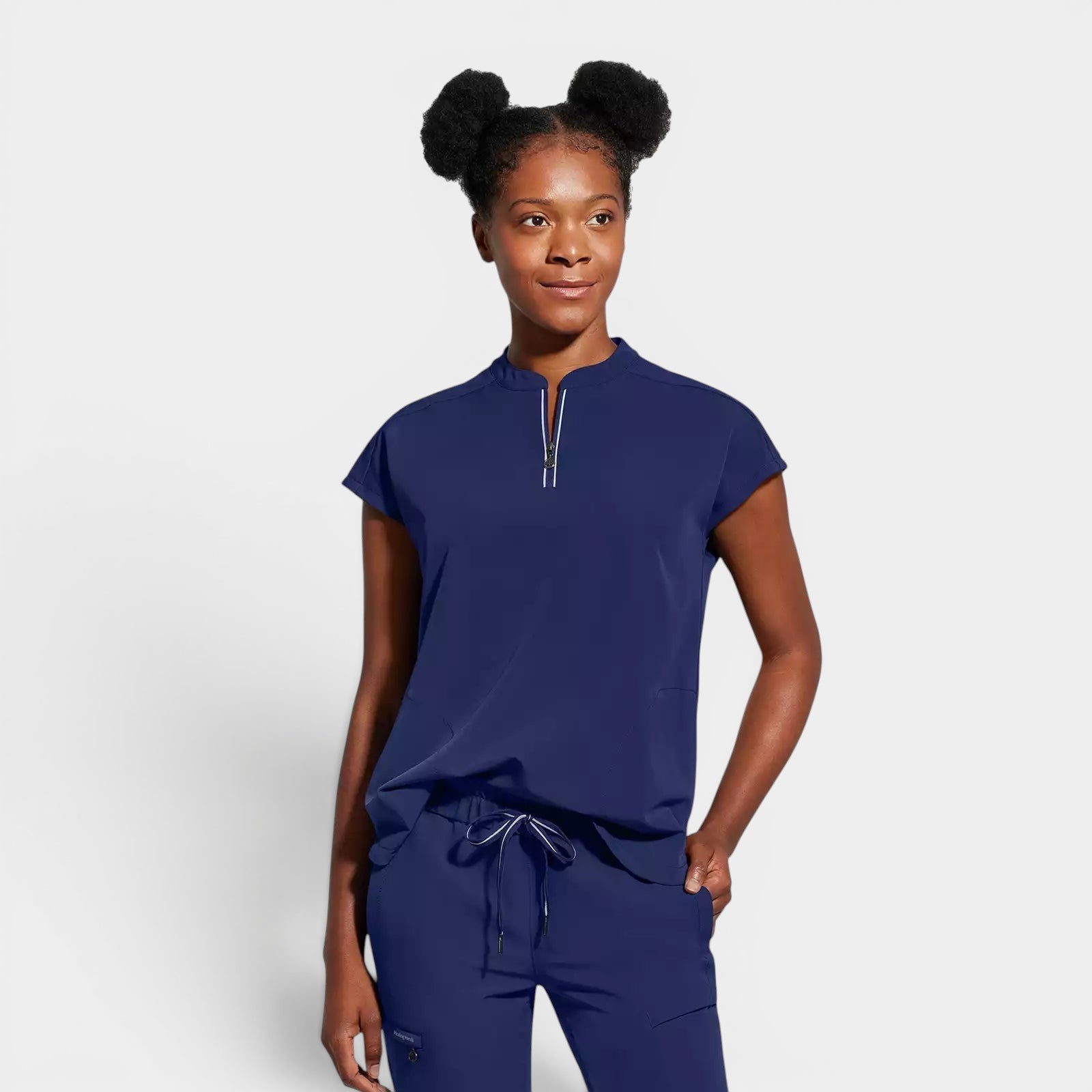 Read's Uniforms navy blue relaxed fit scrub top with dolman sleeves, partial zip front, side vents, and rounded hem.