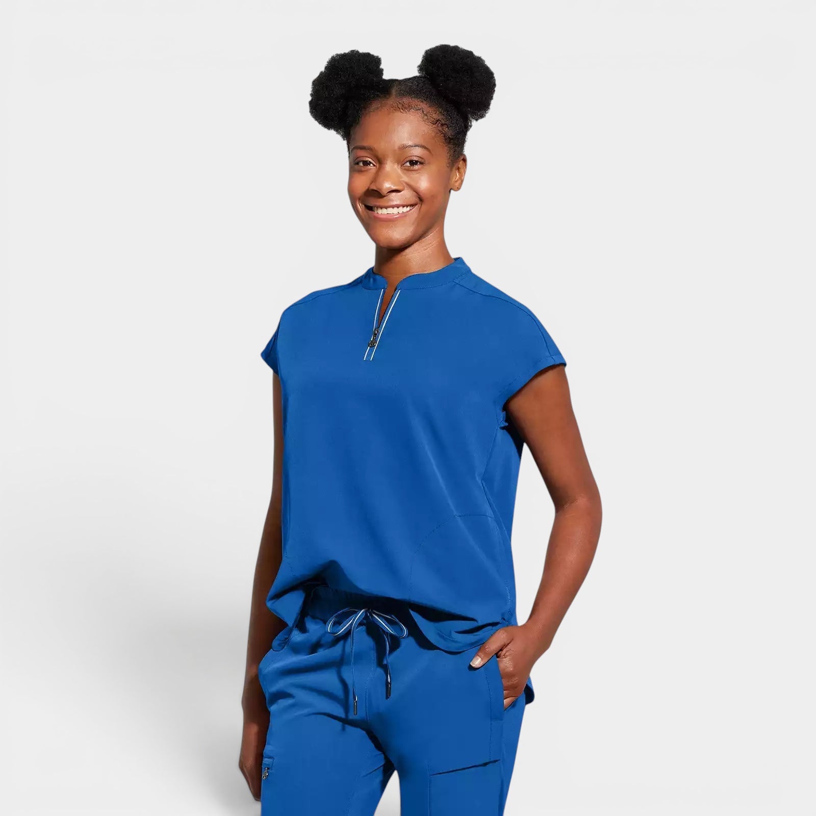 Read's Uniforms royal blue knit scrub top with dolman sleeves, side vents, and partial zip front. Relaxed fit.
