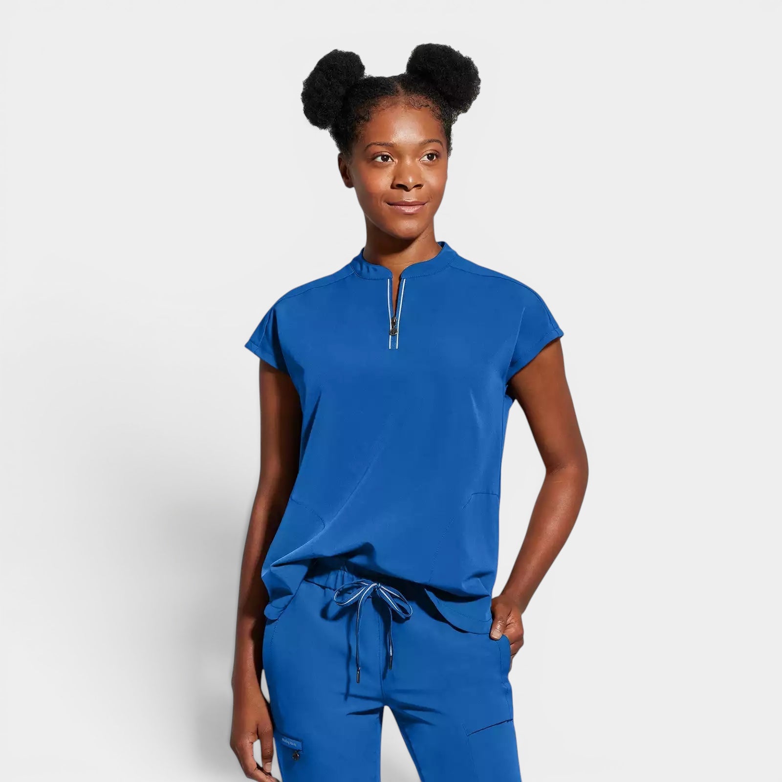 Read's Uniforms royal blue knit scrub top with dolman sleeves, partial zip front, side vents, and rounded hem.