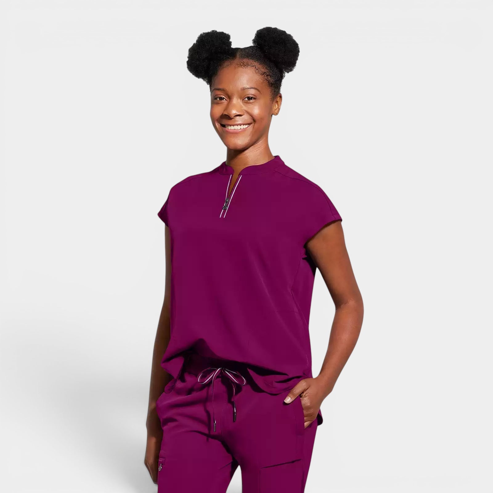 Read's Uniforms plum purple relaxed fit scrub top with partial zip front, dolman sleeves, and rounded hem.
