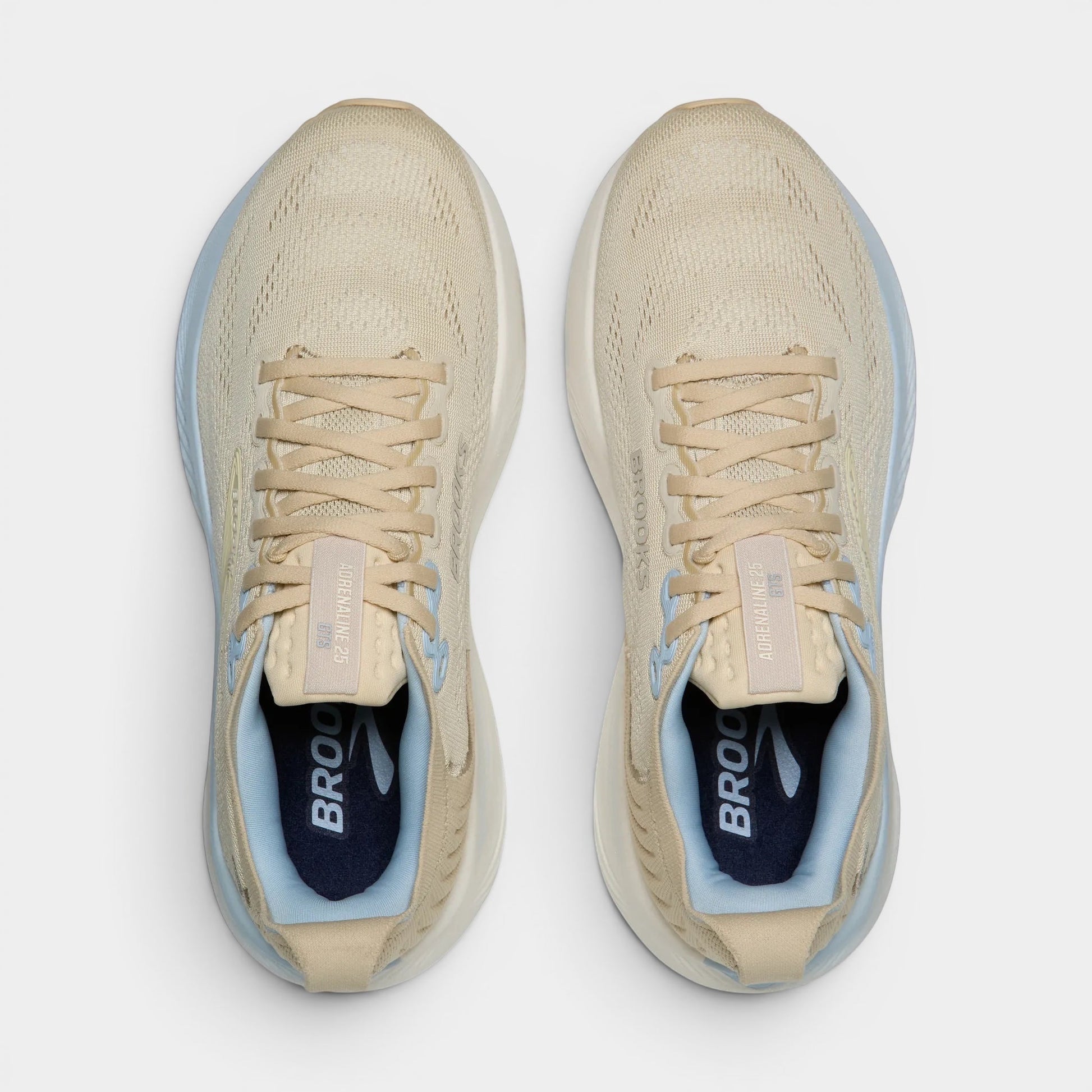 Read's Uniforms Adrenaline GTS 25 women's running shoes in beige with light blue accents. Breathable mesh upper, balanced cushioning, and structured support.