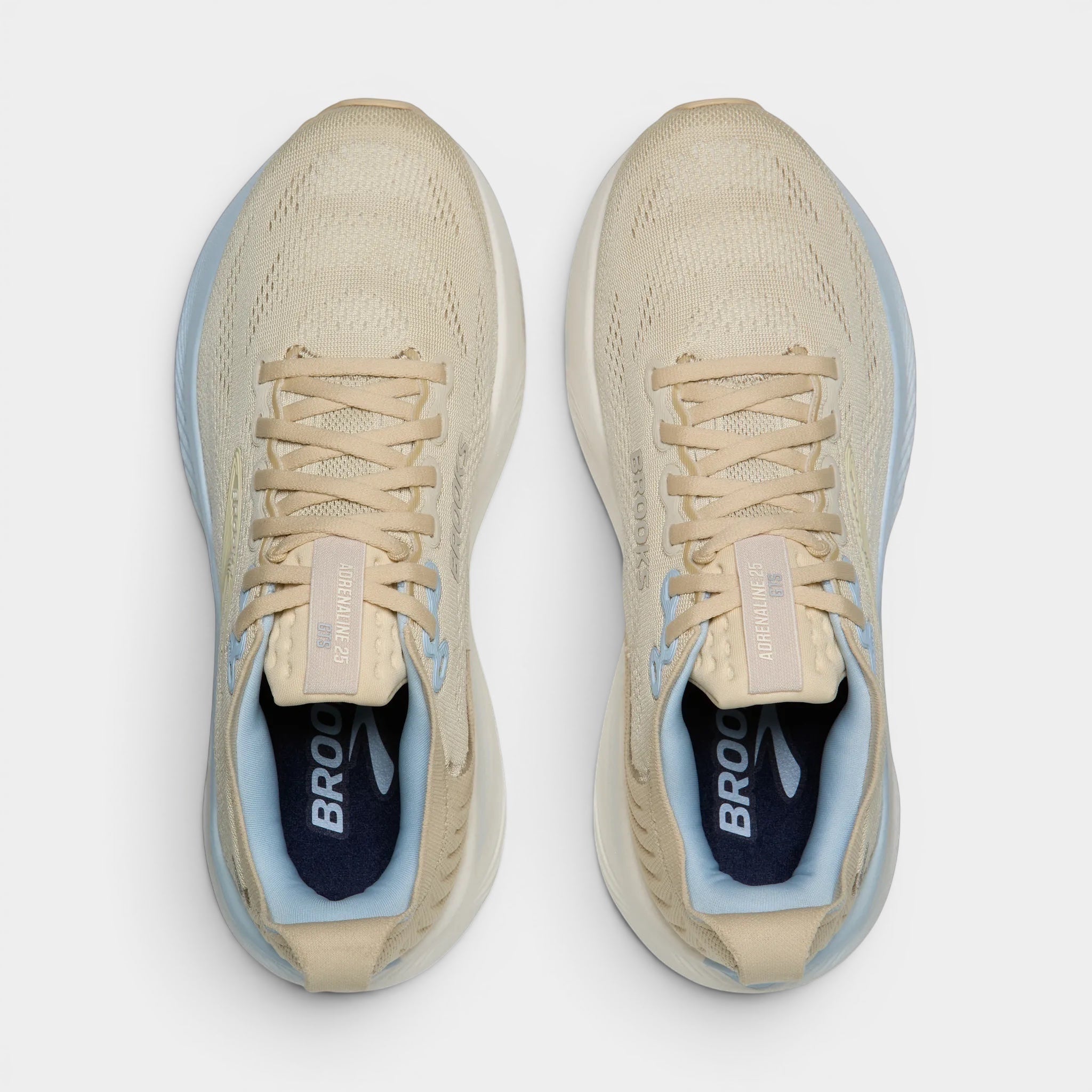 Read's Uniforms Adrenaline GTS 25 women's running shoes in beige with light blue accents. Breathable mesh upper, balanced cushioning, and structured support.